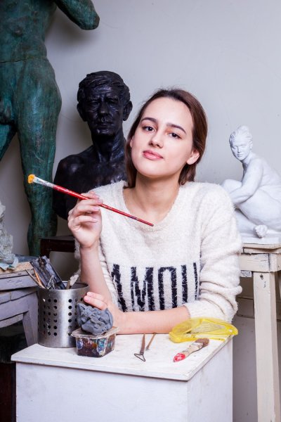 environmental portrait of woman painting